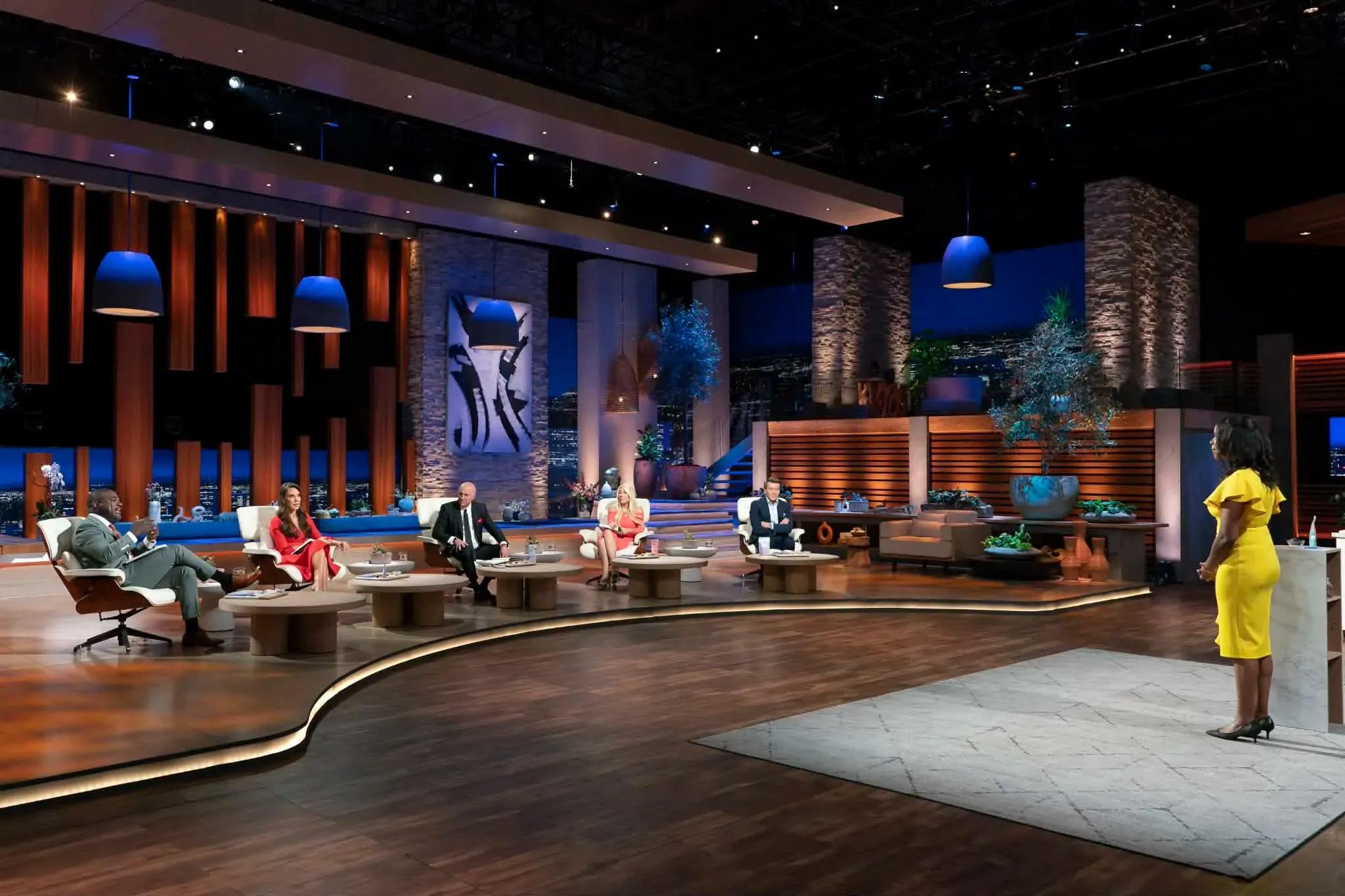Thereasa Black in a yellow dress facing the five Sharks during her Bon AppéSweet pitch.