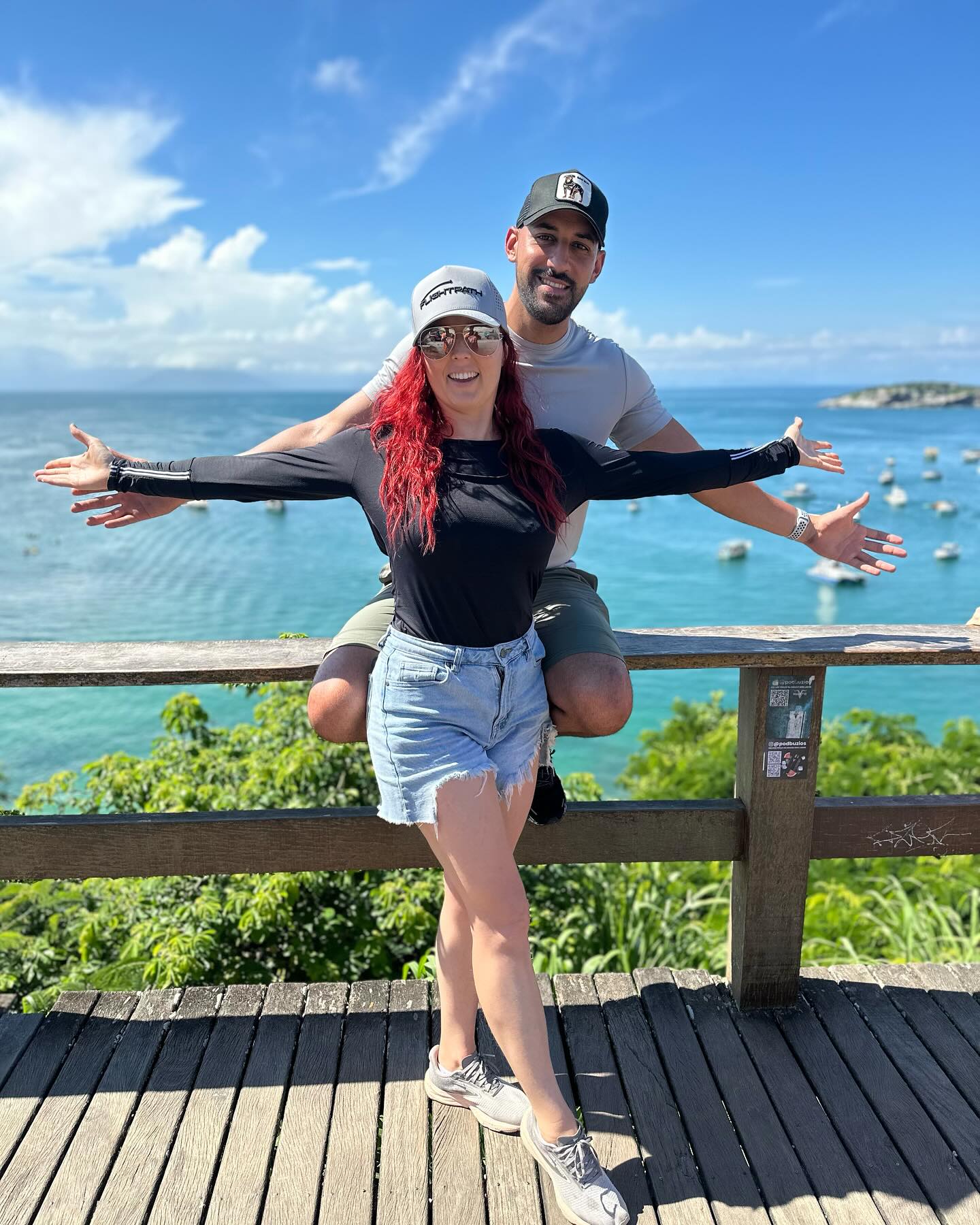 Flightpath Golf owners Caroline Castille Sierra and Michael Sierra posing together by the ocean